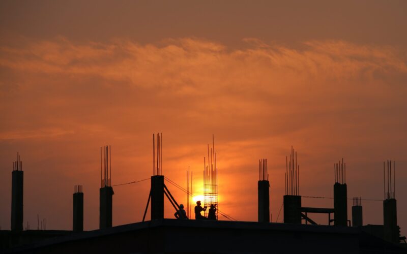 silhouette-of-men-in-construction-site-during-sunset-176342-scaled